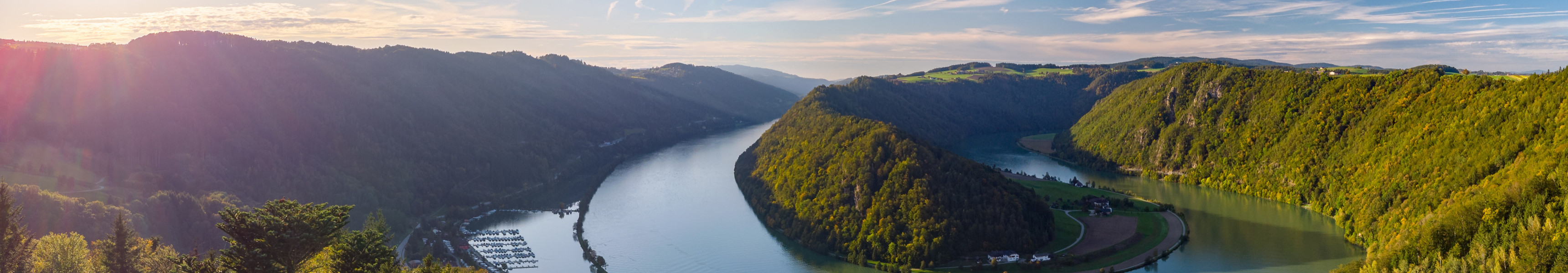 Panoramablick auf die Donauschlinge bei Schl&ouml;gen in Ober&ouml;sterreich mit Fluss, Wald und Schiff bei Sonnenschein
